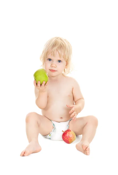 Маленькая девочка с яблоками — стоковое фото