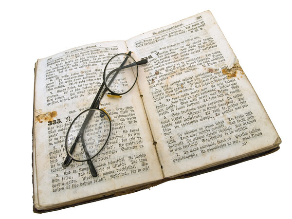 Old open book with glasses