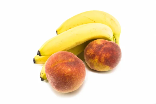 Bananen en perziken — Stockfoto