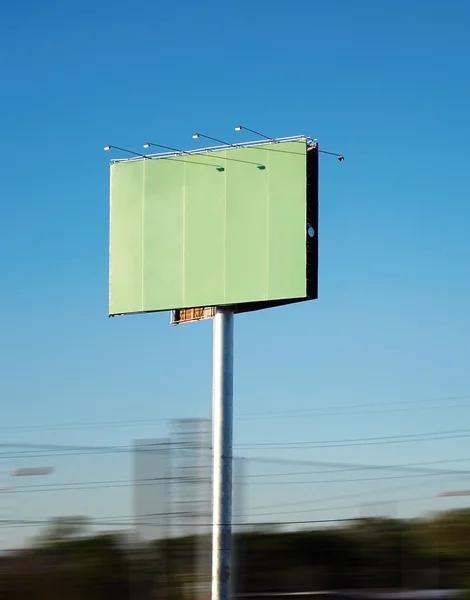 stock image Large green poster near the road against the blue sky