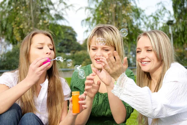 Girls inflating soap-bubbles — Stock Photo, Image