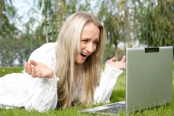 Frau im Park mit Laptop — Stockfoto