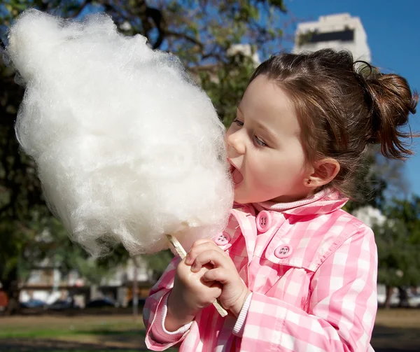 Girl eating candy-floss Royalty Free Stock Photos