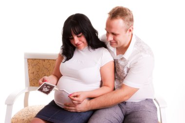 Couple looking at ultrasound picture clipart