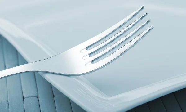 Fork laying on a plate — Stock Photo, Image