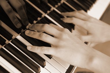 Hands above keys of the piano. Old color clipart