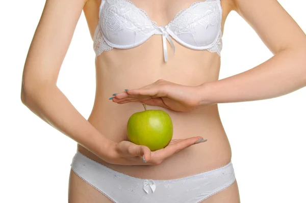 Femmina formosa un corpo e una mela verde — Foto Stock