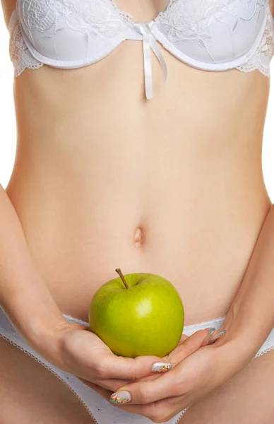 Female shapely a body and a green apple — Stock Photo, Image
