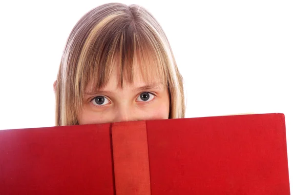 Young girl looks out on a red book — Stock Photo, Image