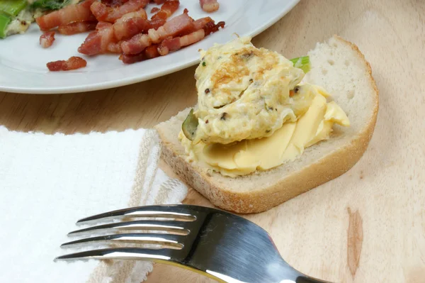 Scrambled eggs on toast and bacon — Stock Photo, Image