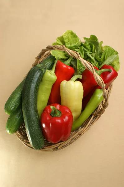 Salad and fresh pepper in a basket — Stock Photo, Image
