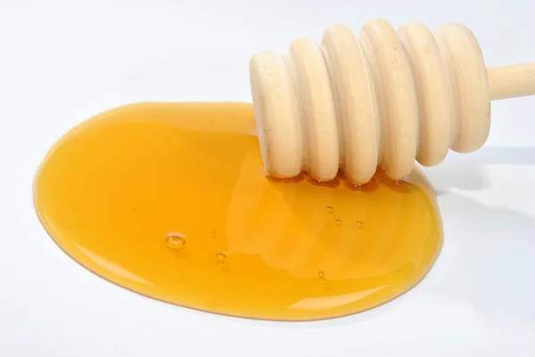 Honey spoon and organic honey — Stock Photo, Image