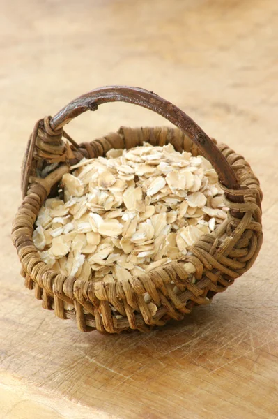Raw porridge in a little basket — Stock Photo, Image
