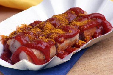 Curried sausage with ketchup clipart