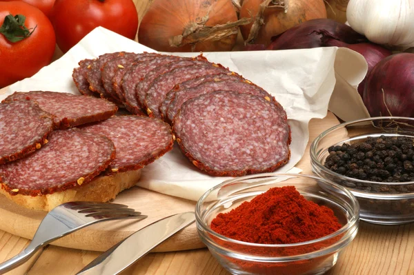 Salami and some slices salami — Stock Photo, Image