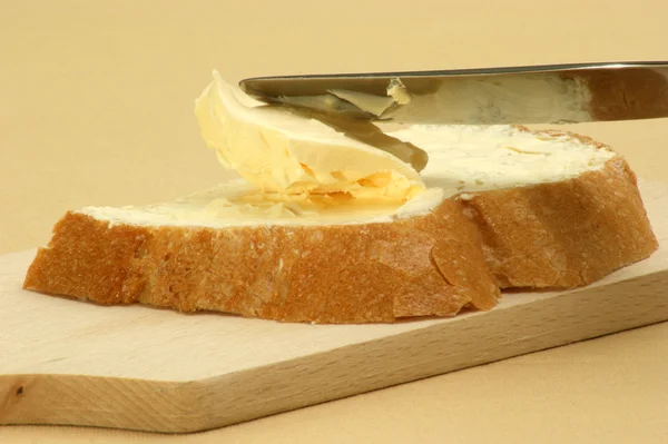 Bread with butter and a knife — Stock Photo, Image