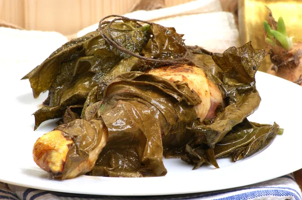 Chicken legs in wine leaves — Stock Photo, Image