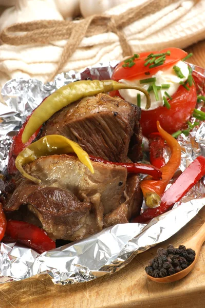 Braised meat in tinfoil — Stock Photo, Image