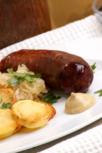 Smoked sausage with organic sauerkraut and potato — Stock Photo, Image