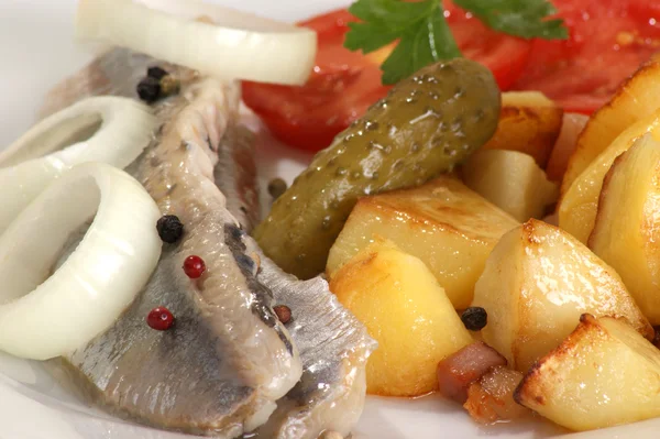 Roasted potato with herring on a white plate — Stock Photo, Image