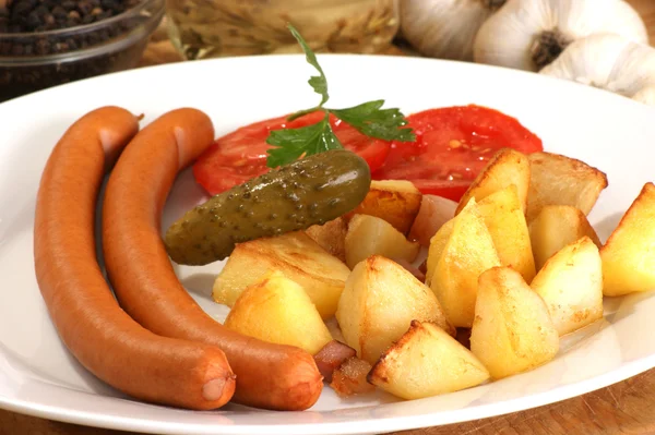 stock image Roasted potato with two home made sausages