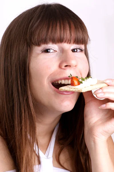 A young woman does not like this crisp bread — Stock Photo, Image