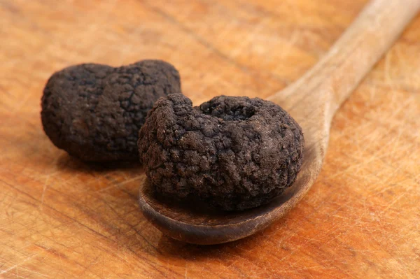 stock image Some organic summer truffle on a timber spoon