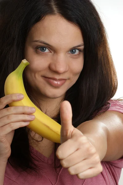 A young woman likes this organic banana — Stock Photo, Image