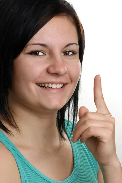 Молодая женщина появляется с кончиком пальца — стоковое фото