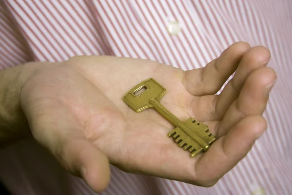 House key in palm — Stock Photo, Image