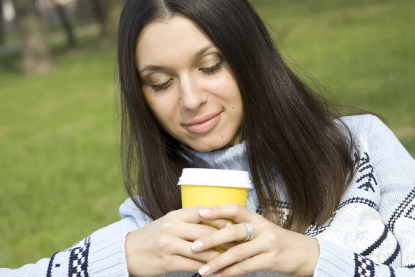 Kahve içme bir parkta güzel bir kız — Stok fotoğraf