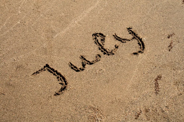 Text auf dem Sand — Stockfoto