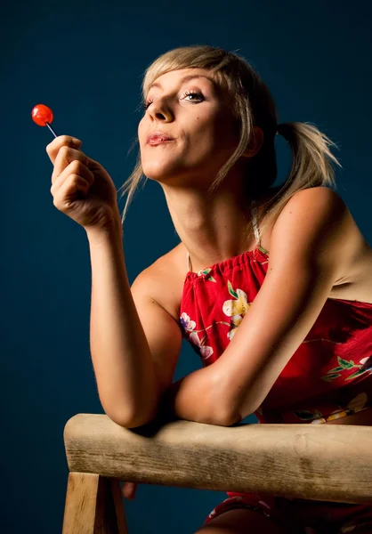 Cute blonde posing with a lollipop — Stock Photo, Image