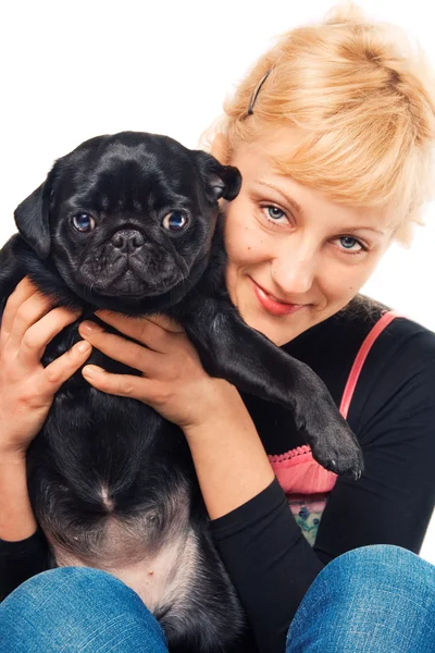 Cute blonde holding a pug — Stock Photo, Image