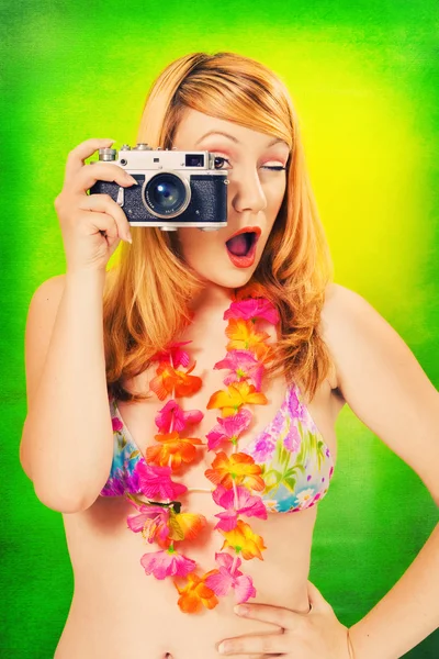 Pinup girl in a bikini holding a vintage camera — Stock Photo, Image