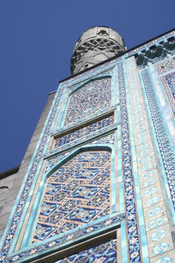 Minaret of a mosque against the sky clipart