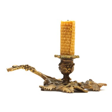 Old bronze candlestick with a candle isolated clipart