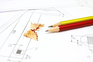 Two pencils, plans and blueprints for an architect's design draw clipart