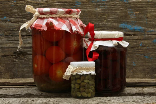 Preserve. Jar with strawberry jam, pickled tomatoes and capers — Stock Photo, Image
