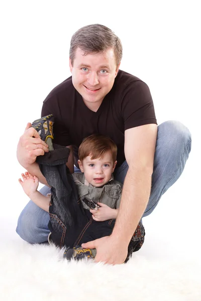 Rodzina: ojciec i syn. Mężczyzna w średnim wieku gra z małym chłopcem — Zdjęcie stockowe