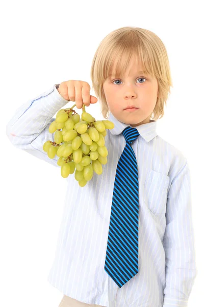 Blond boy holding green grapes. Series. Isolated over white — Stock Photo, Image