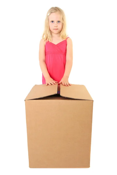 stock image Beautiful girl opens a large cardboard box with a copy space for