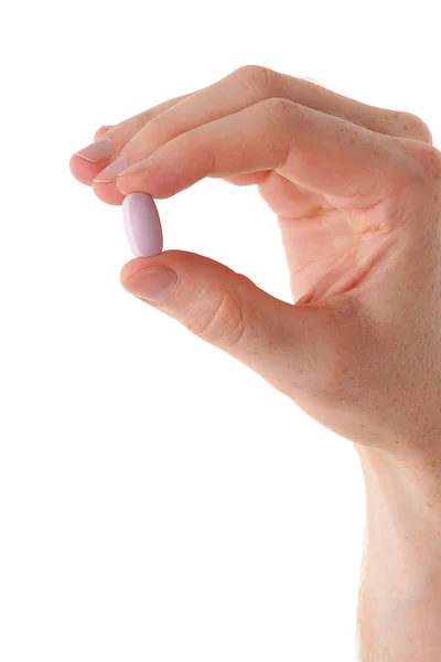 Männliche Hand mit Pille über weißem Hintergrund — Stockfoto