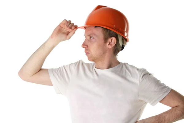 Worker in an orange helmet looks into the distance — Stock Photo, Image