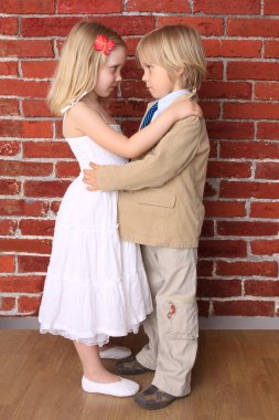 Little boy hugging a beautiful girl. Love concept. Series clipart