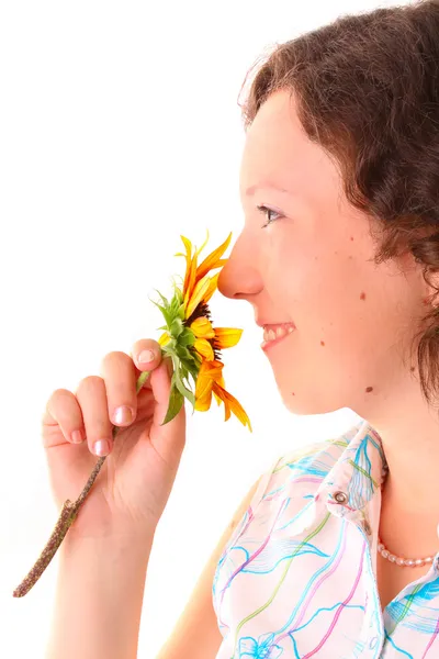 Beautiful girl sniffs a flower — Stock Photo, Image