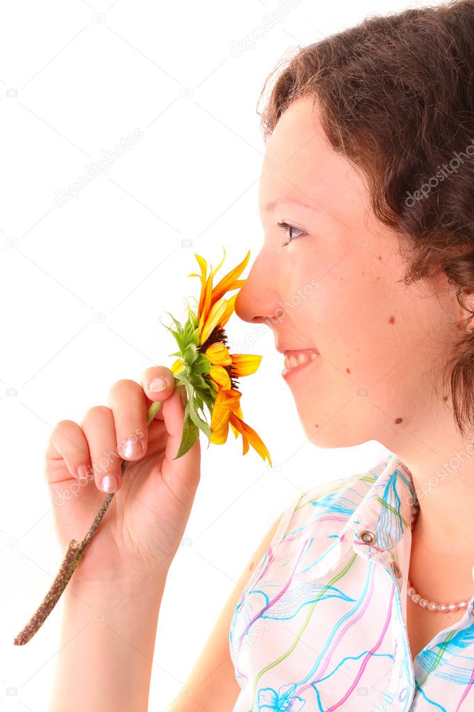 Beautiful girl sniffs a flower