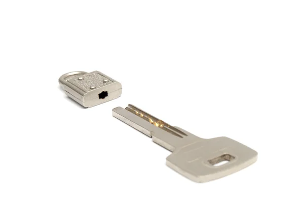 Small padlock and a big key — Stock Photo, Image