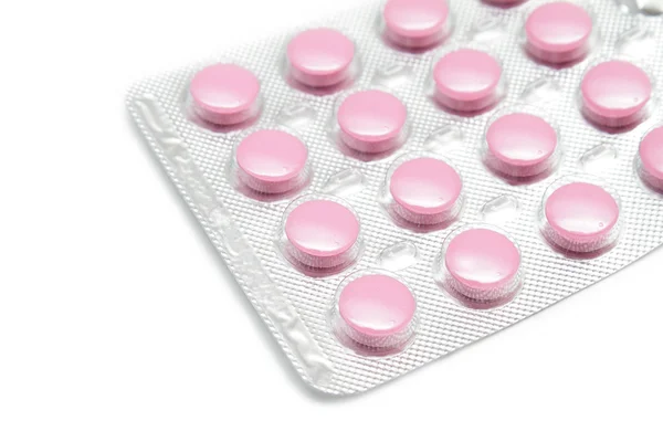 Pillole rosa nel pacchetto su sfondo bianco — Foto Stock