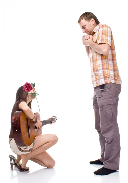 Girl plays the guitar for a boy — Stock Photo, Image